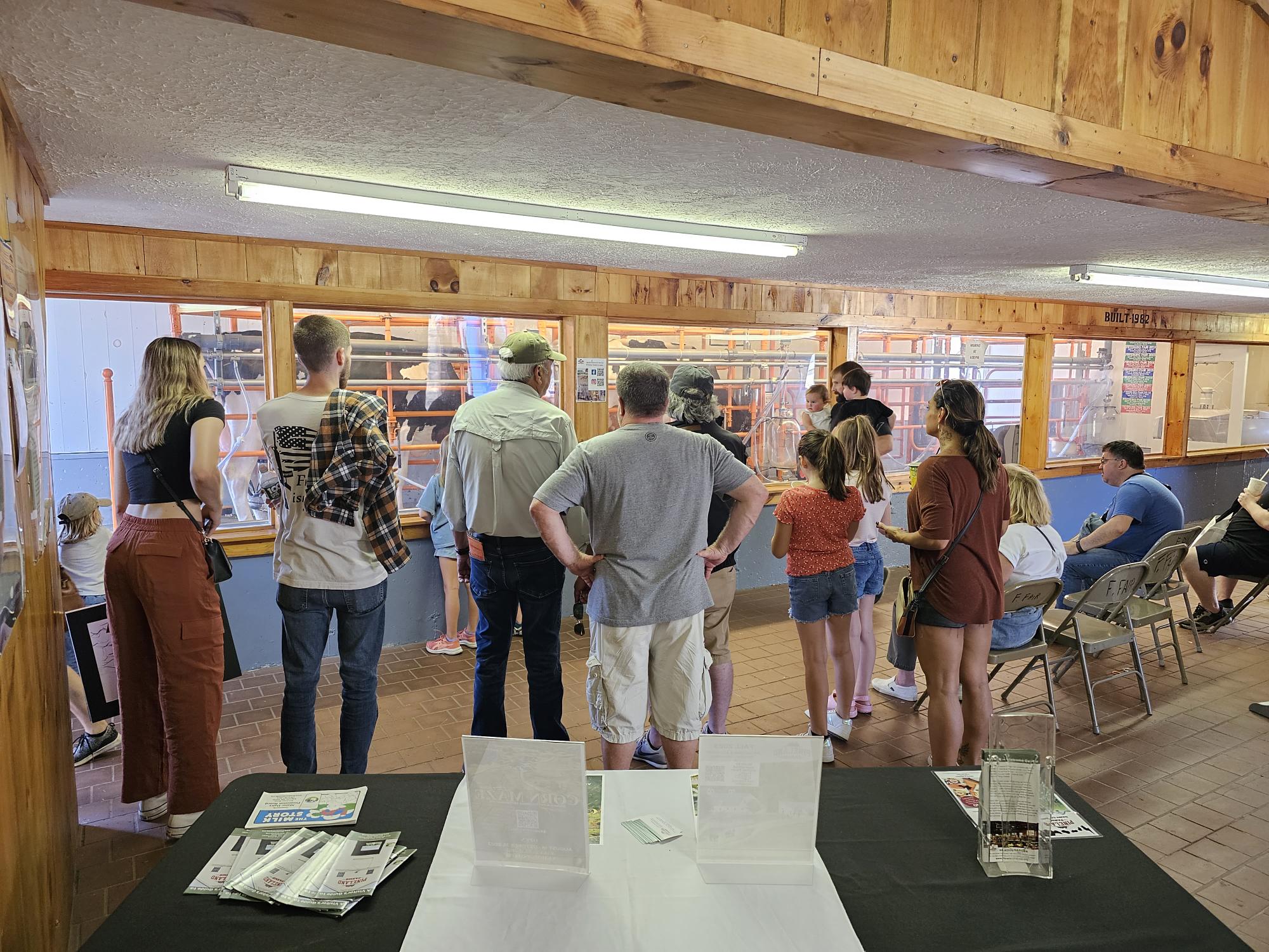 People in milking parlor at the Fryeburg Fair